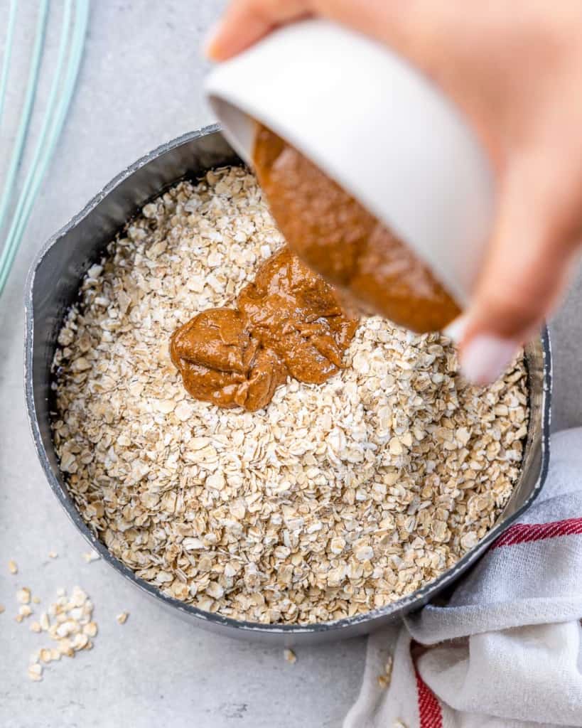 peanut butter being poured into oats