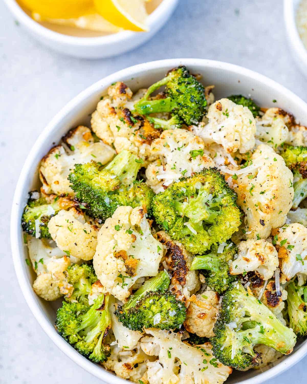 bowl of roasted cauliflower and broccoli with lemon and garlic 