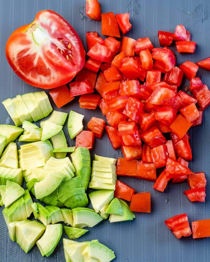 chopped tomatoes and avocados on a cutting board