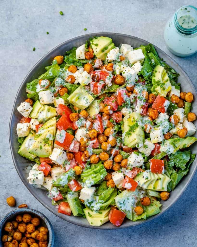 top view os roasted chickpea salad with avocado and feta cheese in a gray bowl