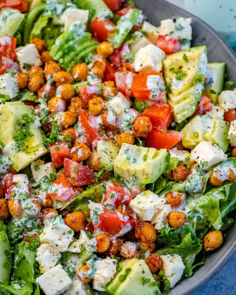 close up roasted chickpea salad with feta cheese and avocado