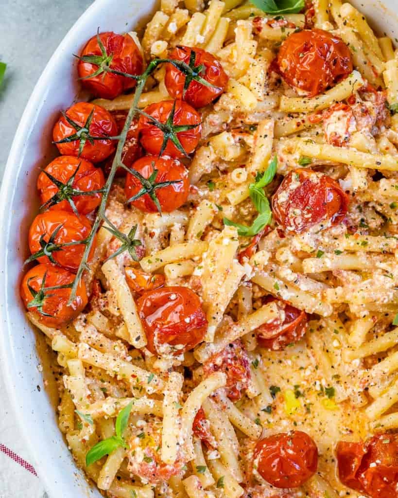 top and close up view of baked pasta with feta and cherry tomatoes 