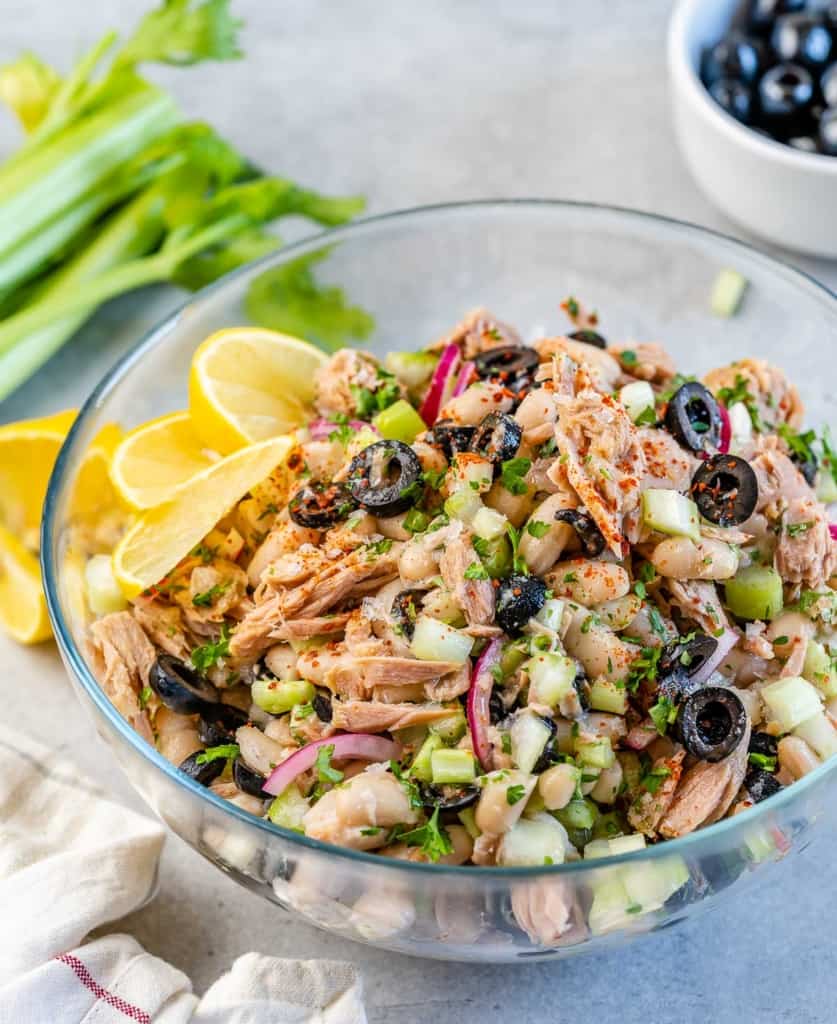side shot of tuna white bean salad in a clear bowl