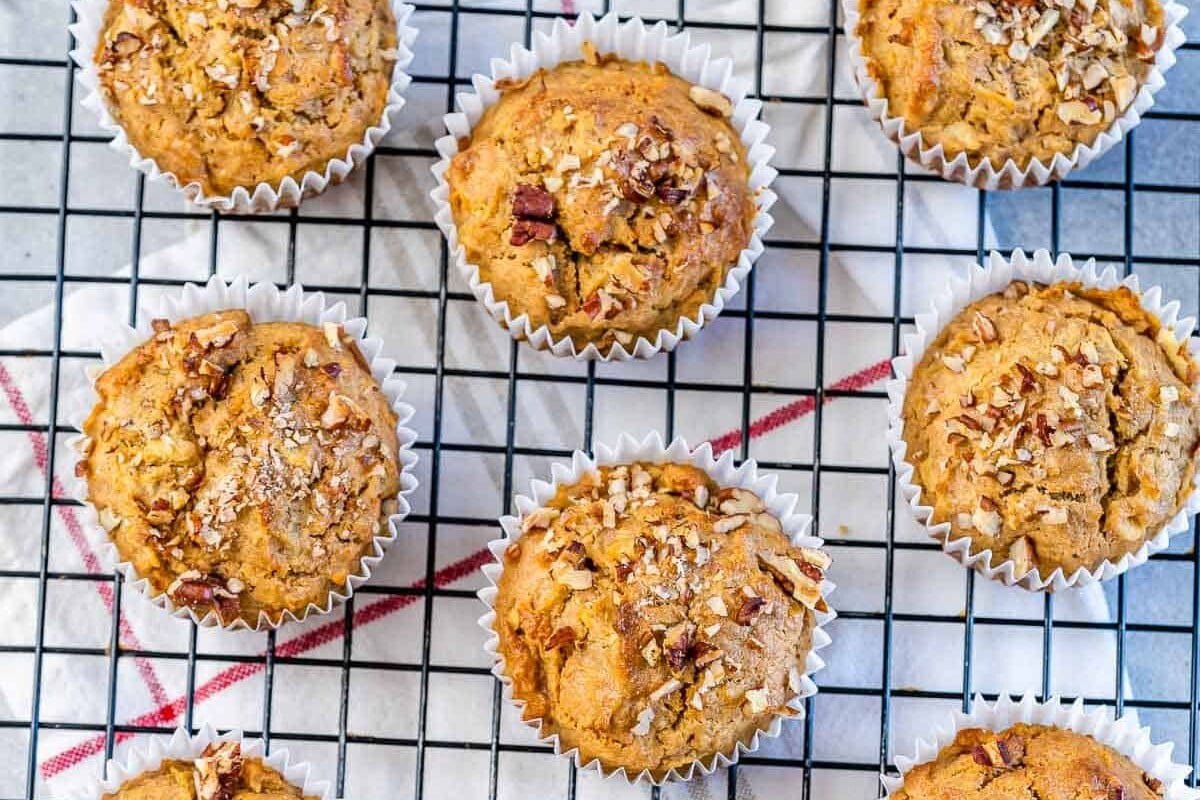 Apple muffins on a wire rack.