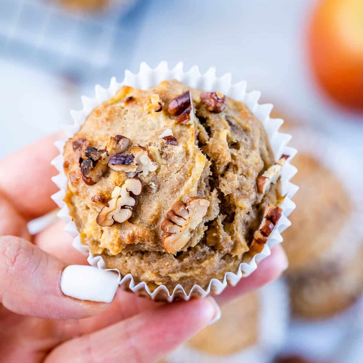 close up of one apple muffin with pecans
