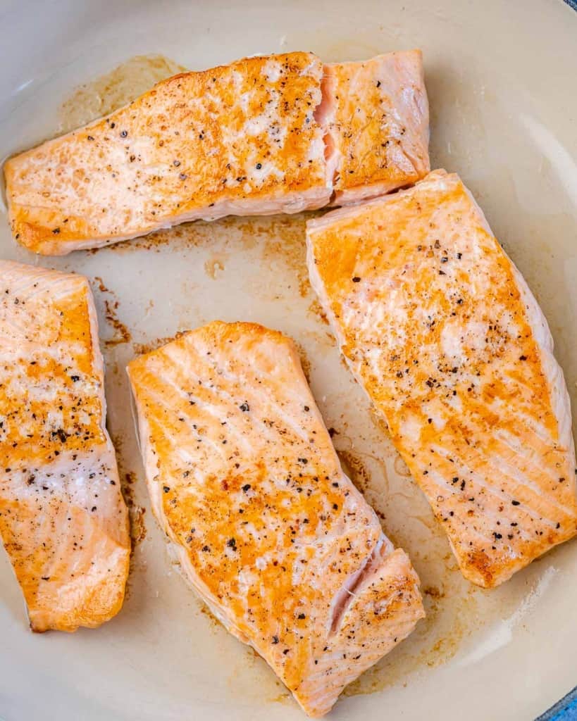 cooked salmon fillets in a pan