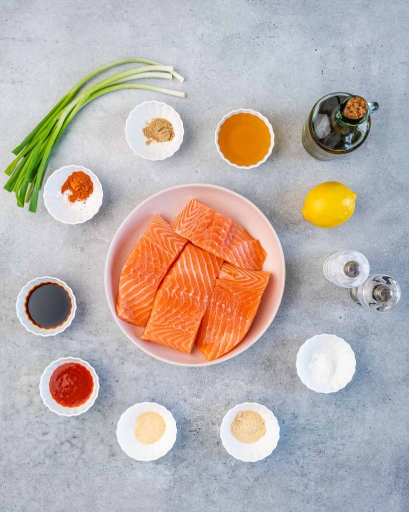 ingredients to make the honey glazed salmon lined up on a flat surface