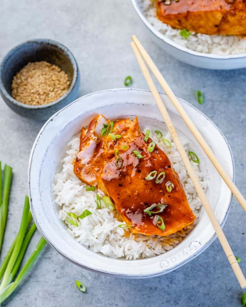 top view of honey salmon filet over a bowl of white rice 