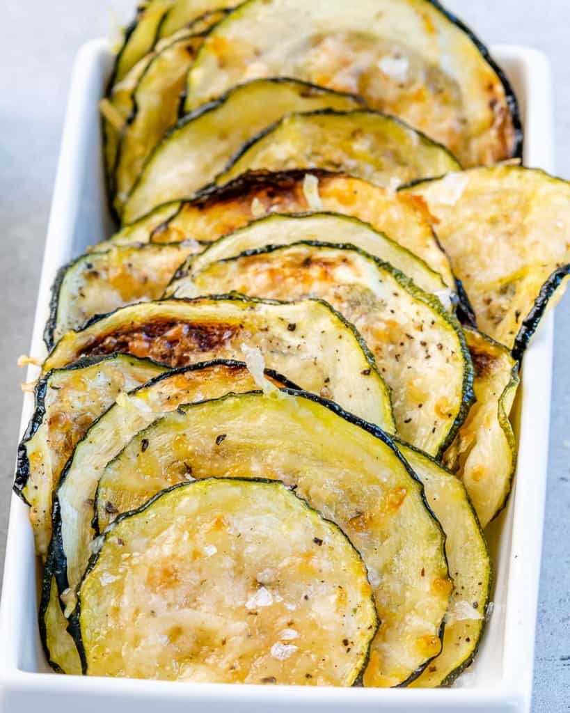 close up crispy zucchini chips placed in a small dish 