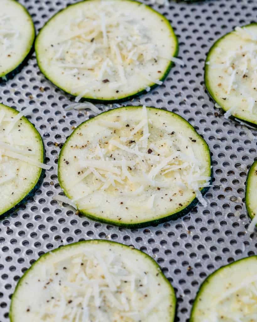 zucchini laid flat with parmesan cheese and black pepper sprinkled over it.