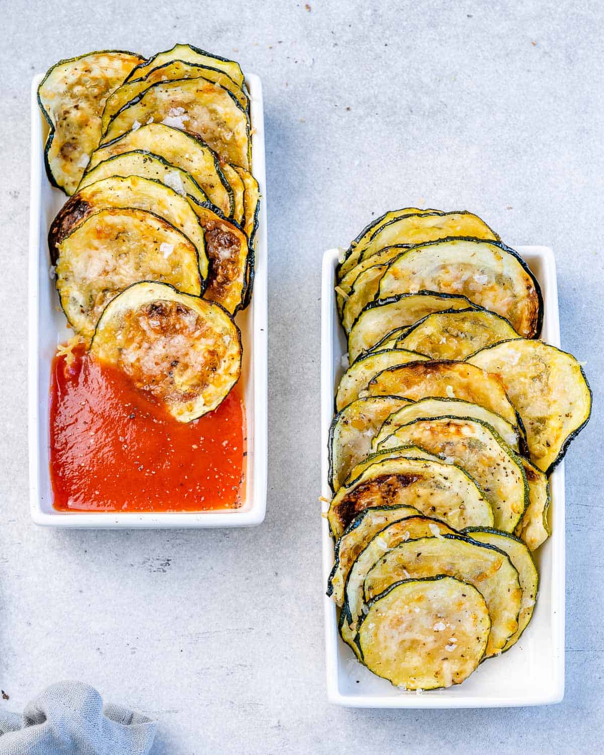 two small bowls of zucchini chips, one of them with marinara sauce