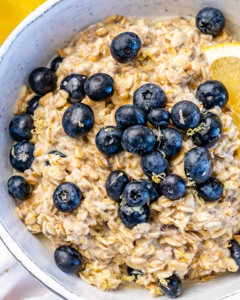 one bowl filled with oats topped with blueberries and lemon