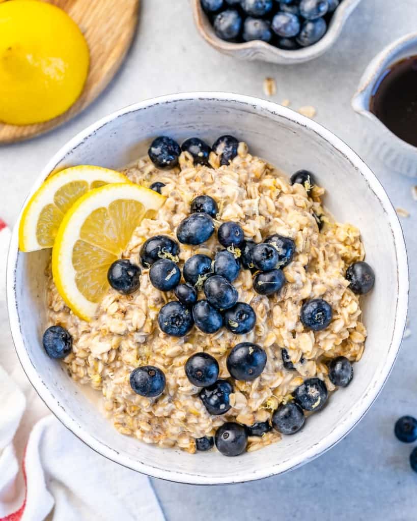 one bowl with overnight oats with blueberries and lemon wedges