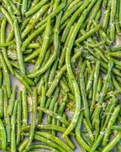 close up image of green beans on a sheet pan
