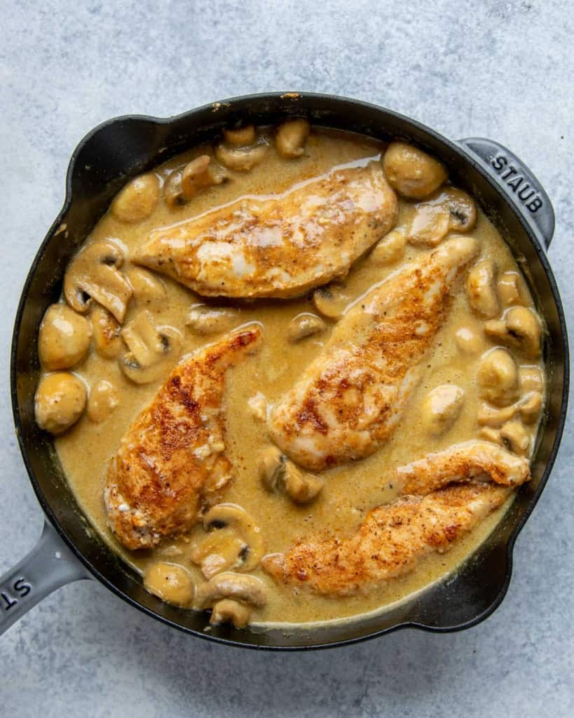 chicken breast placed back into the creamy mustard sauce