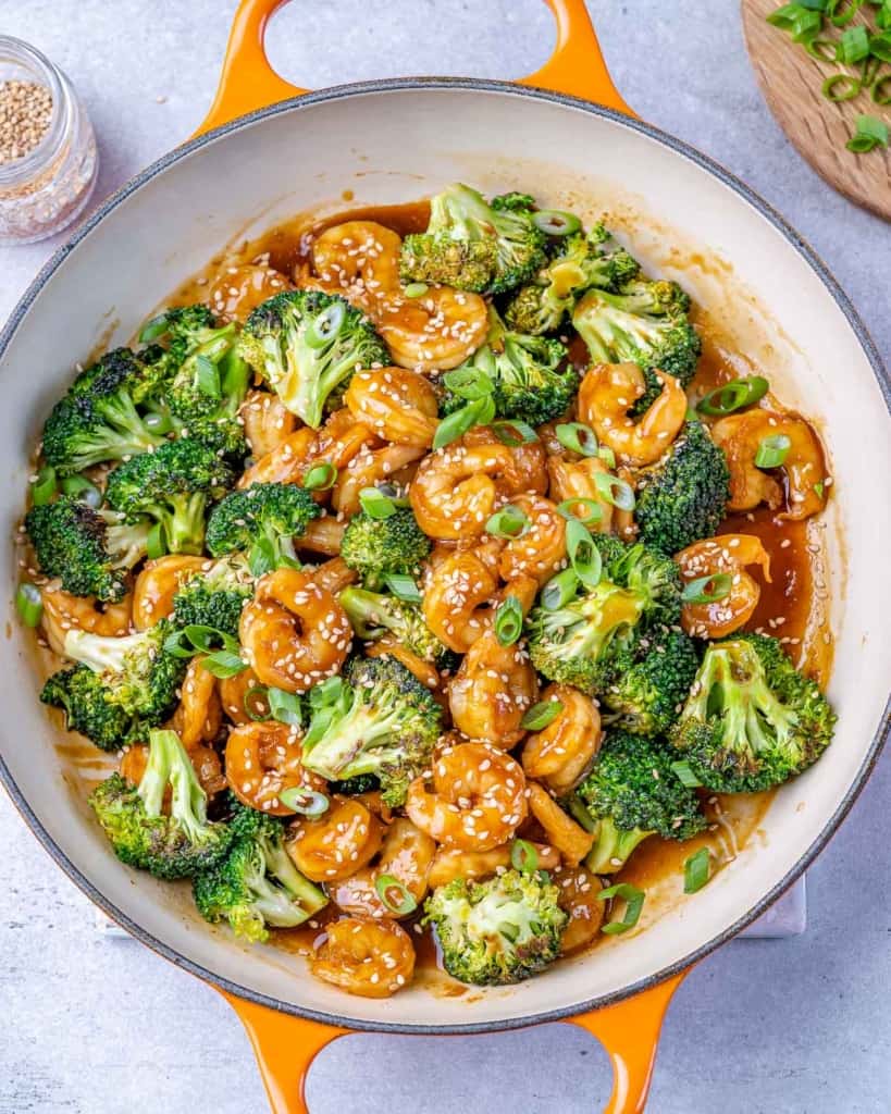 cooked shrimp and broccoli in skillet with teriayki sauce