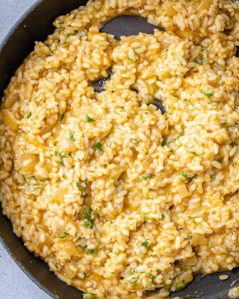 top view of creamy risotto in a black skillet