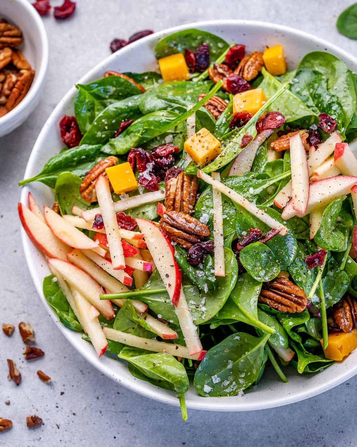 one white bowl with apple pecan salad and homemade vinaigrette 