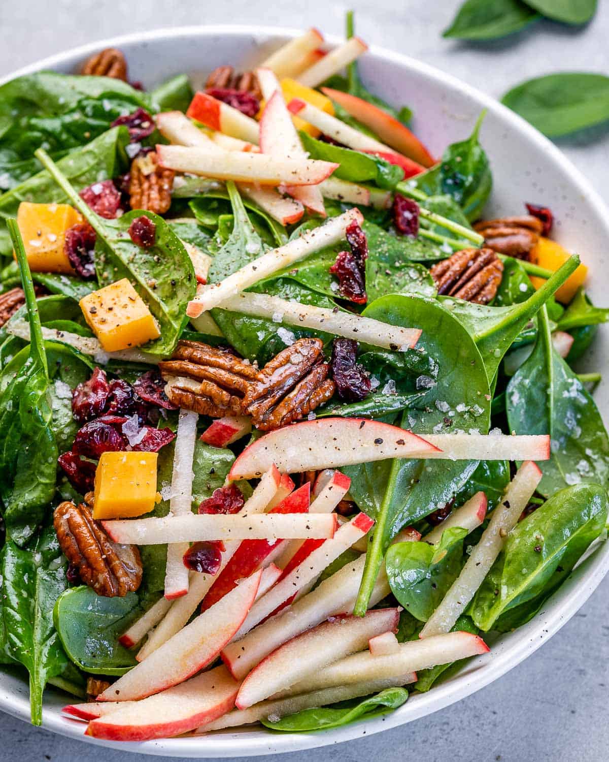 apple pecan salad with cheddar cheese, vinaigrette, and cranberries
