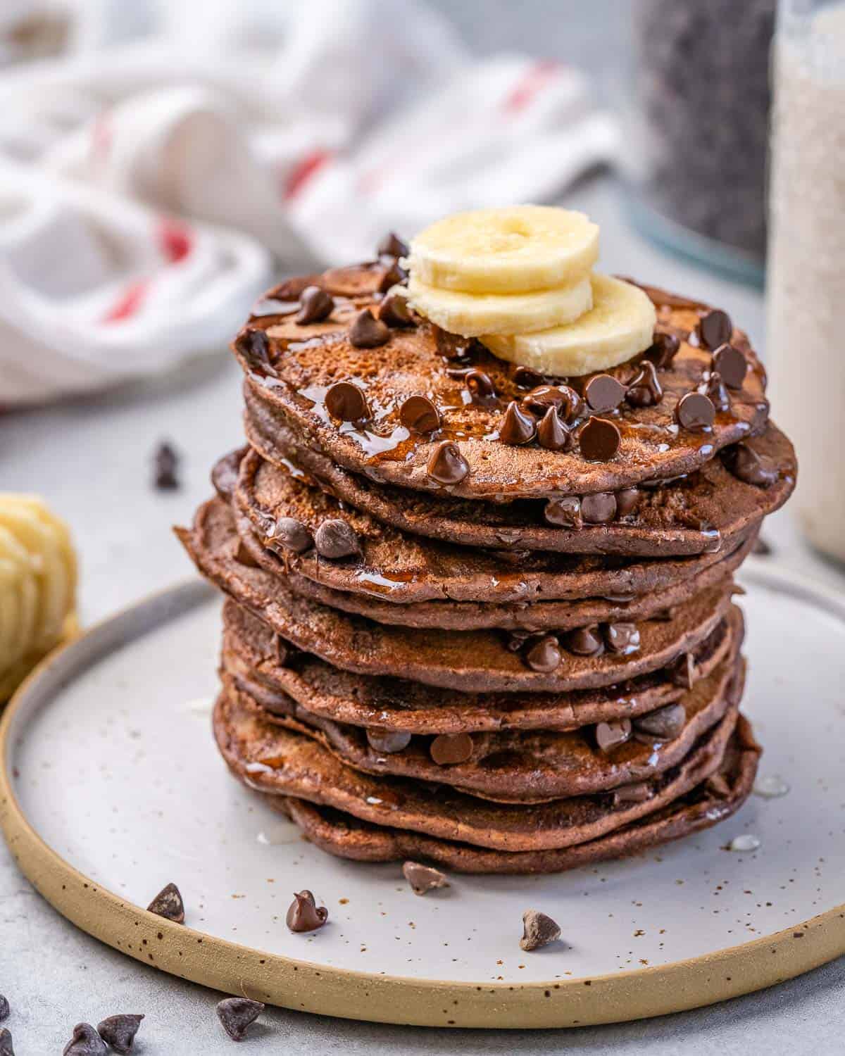one stack of oatmeal pancakes with chocolate chips and banana