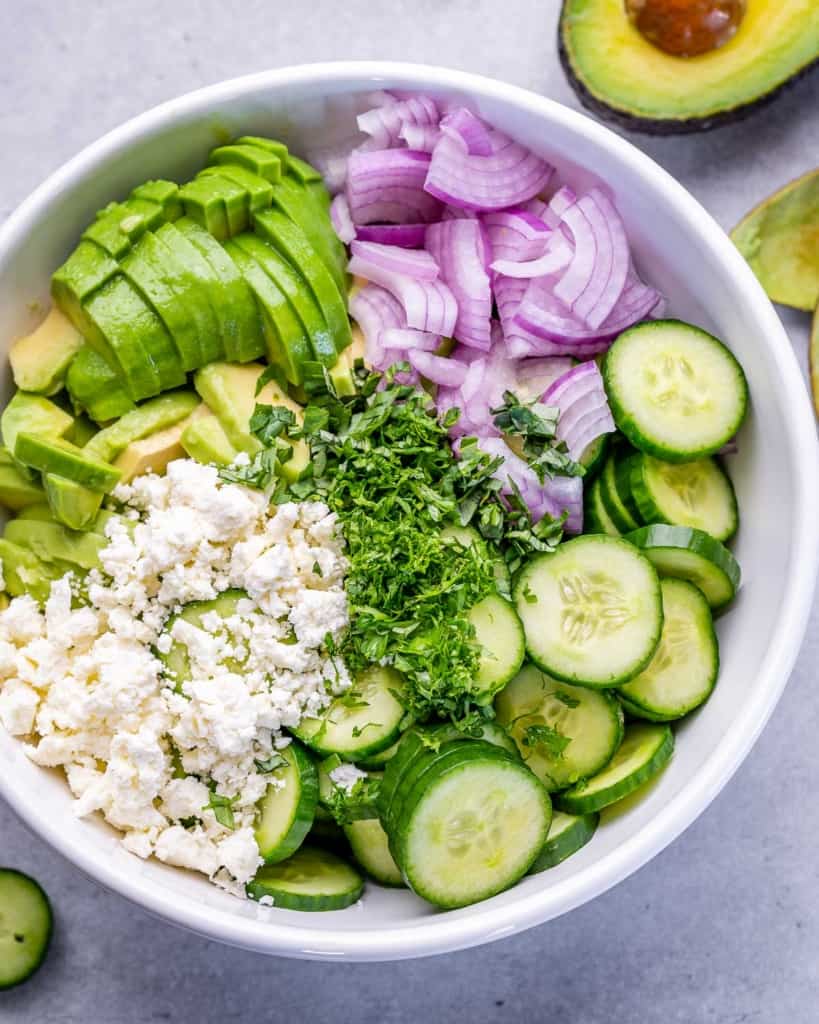 ingredients of salad added to a bowl before mixing