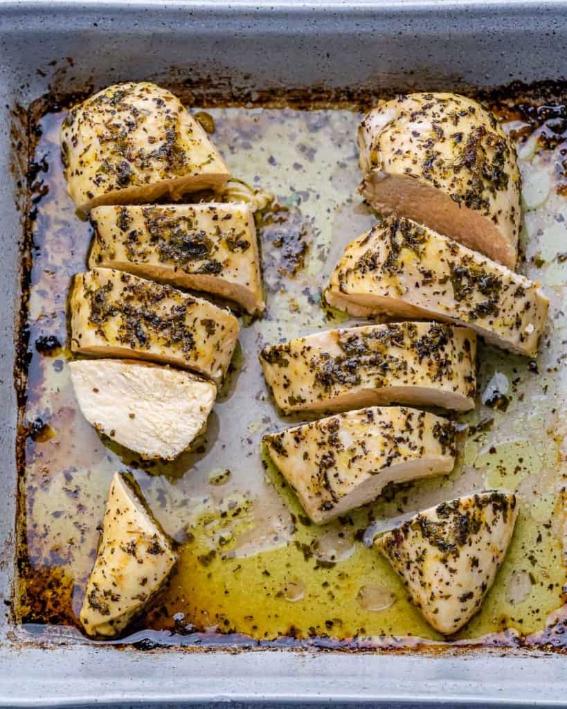 baked sliced chicken breast in a white dish