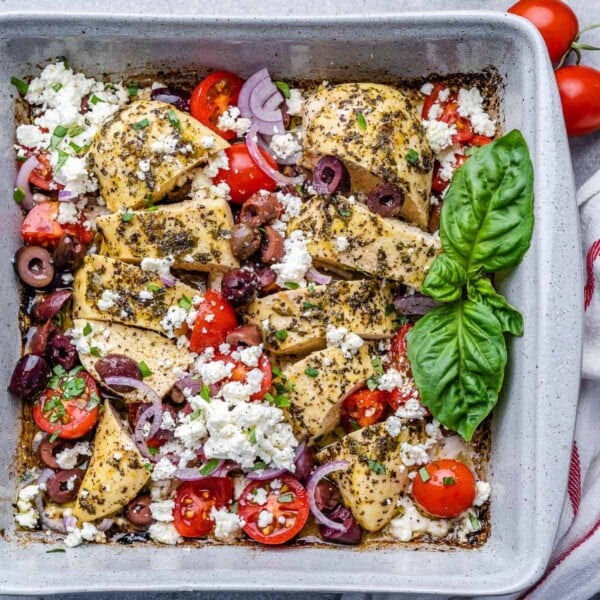 top view of baked chicken breast with feta cheese olives and tomatoes