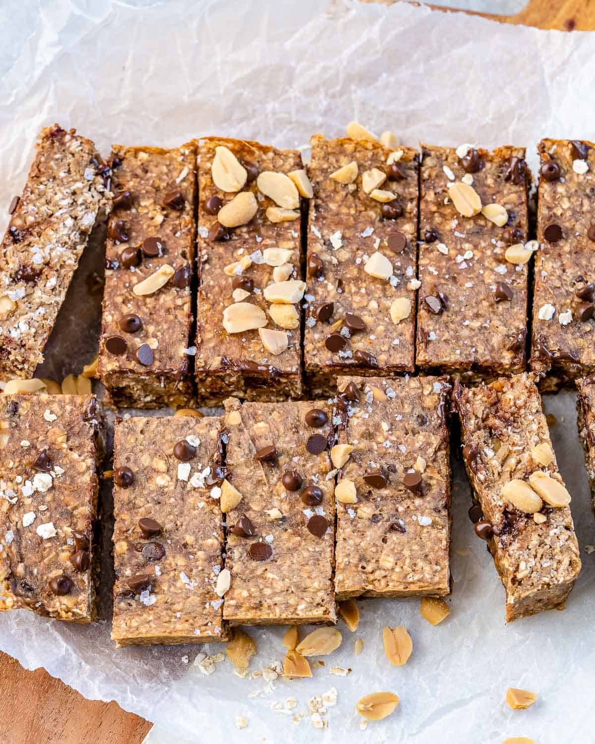 top view of twelve oatmeal bars with chocolate chips and peanuts