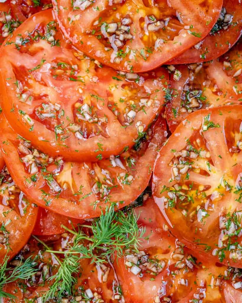 close up sliced marinated tomatoes 