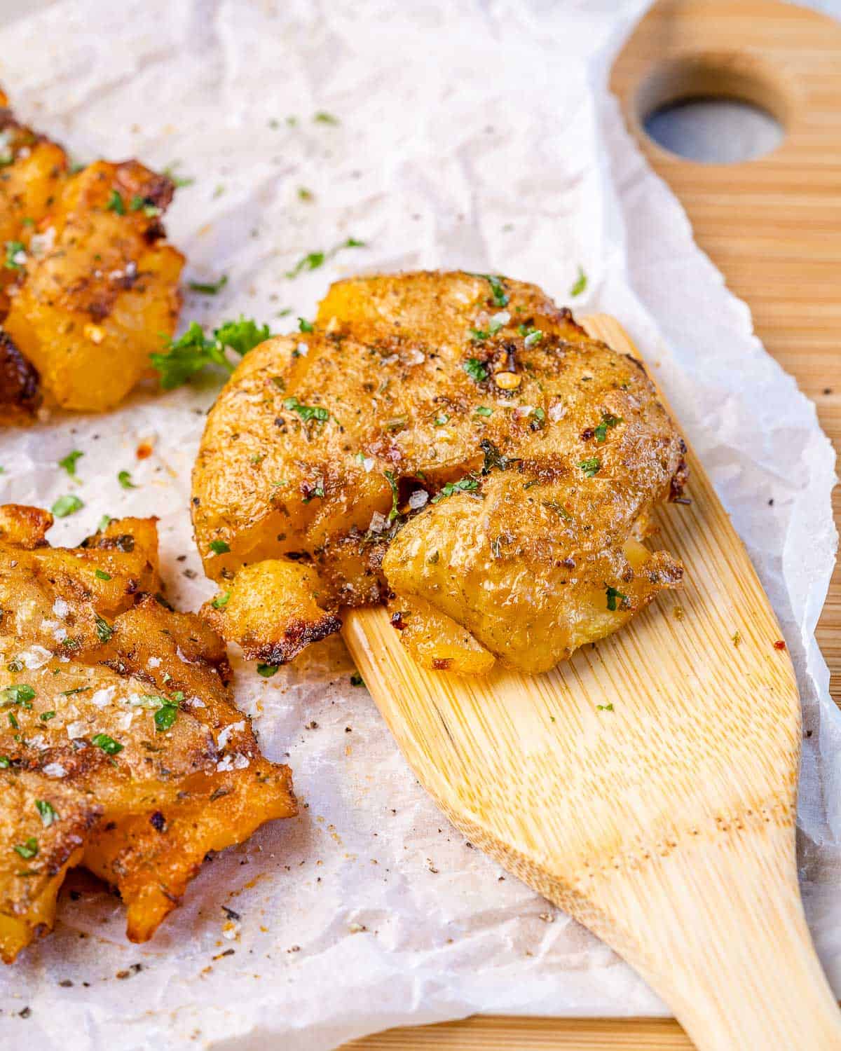 close view of smashed potato on wooden spoon