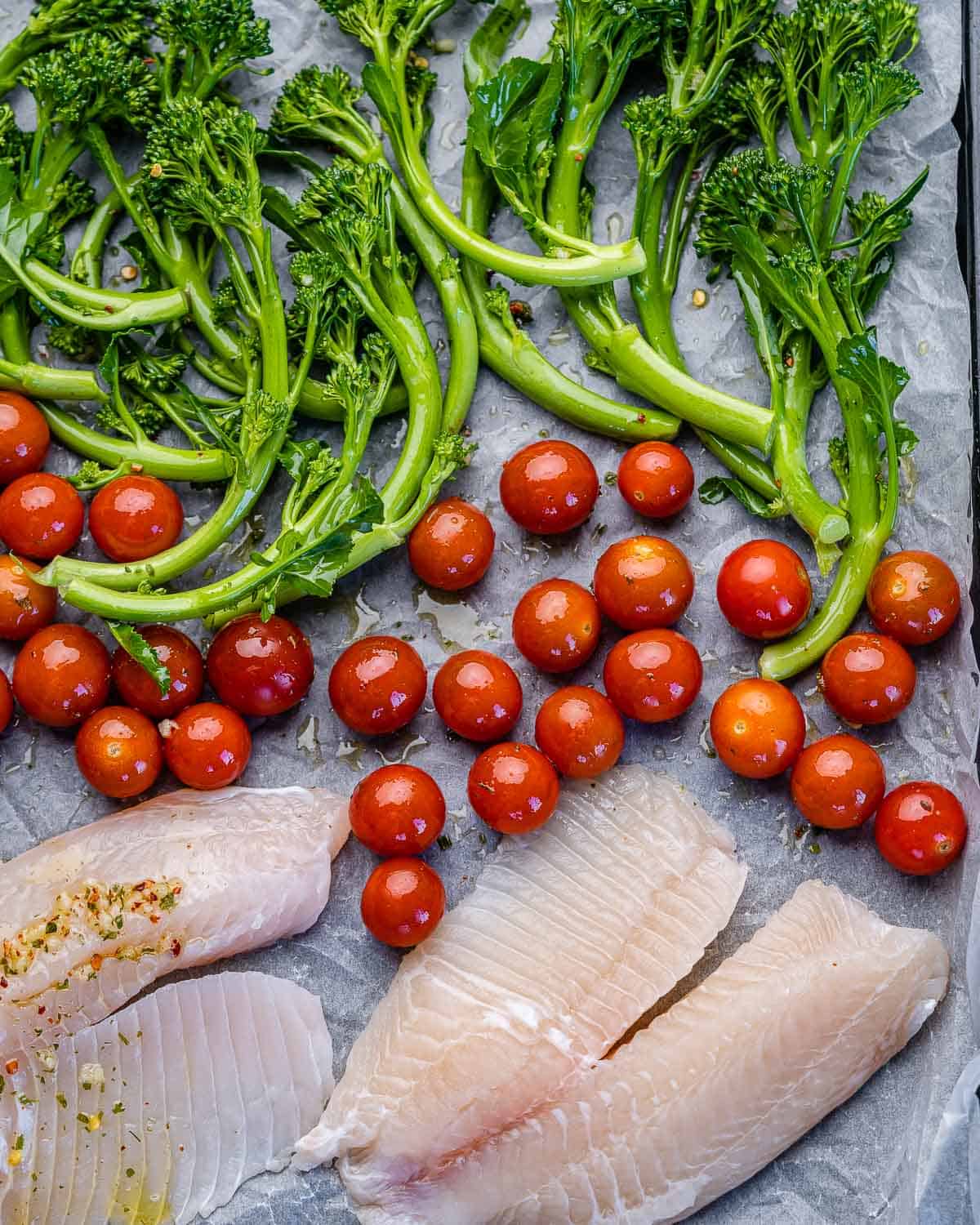 sheet pan with tilapia fillets, broccolini, and tomatoes