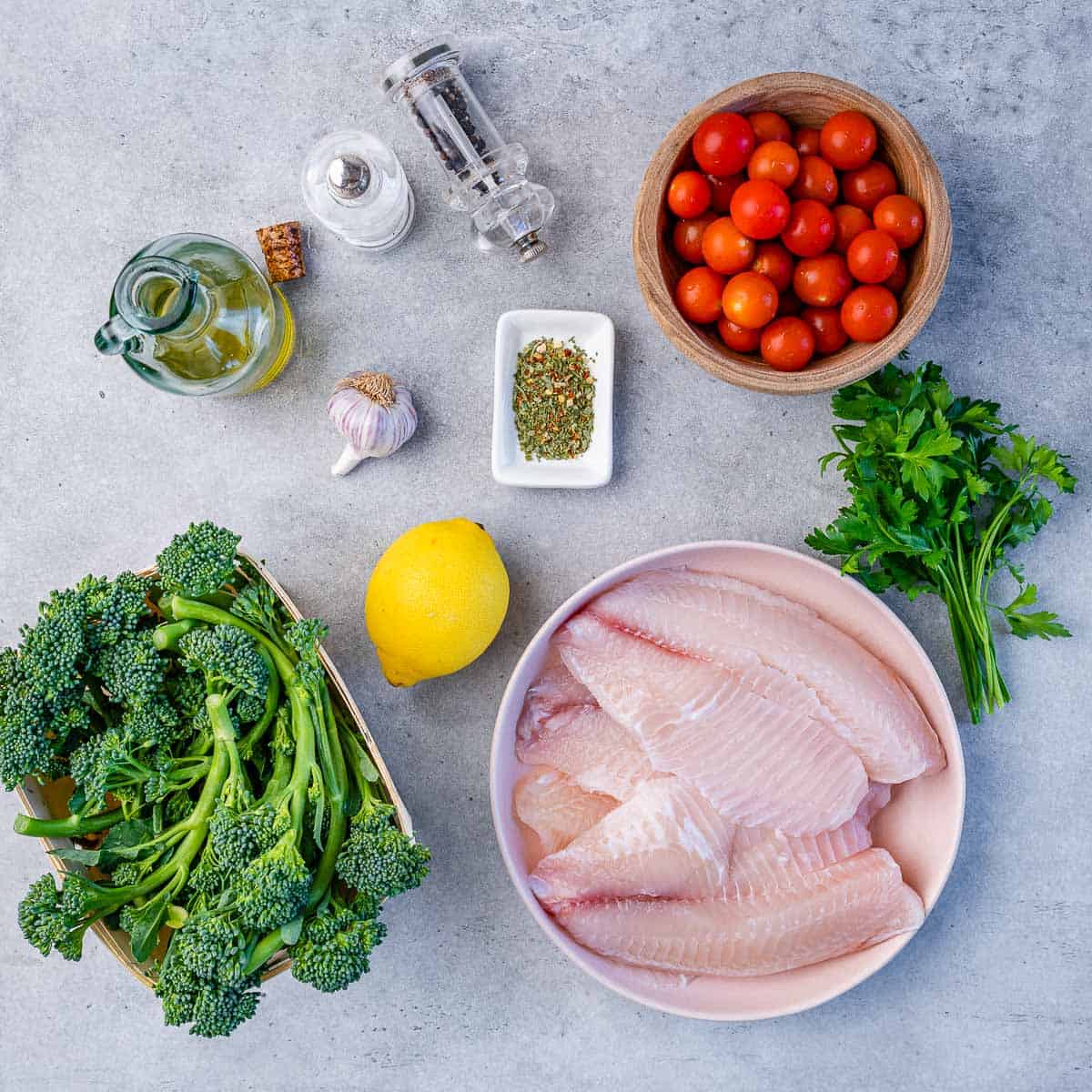 tomatoes, salt, pepper, oil, lemon, garlic, Italian seasoning, tilapia fish fillets, broccolini, parsley