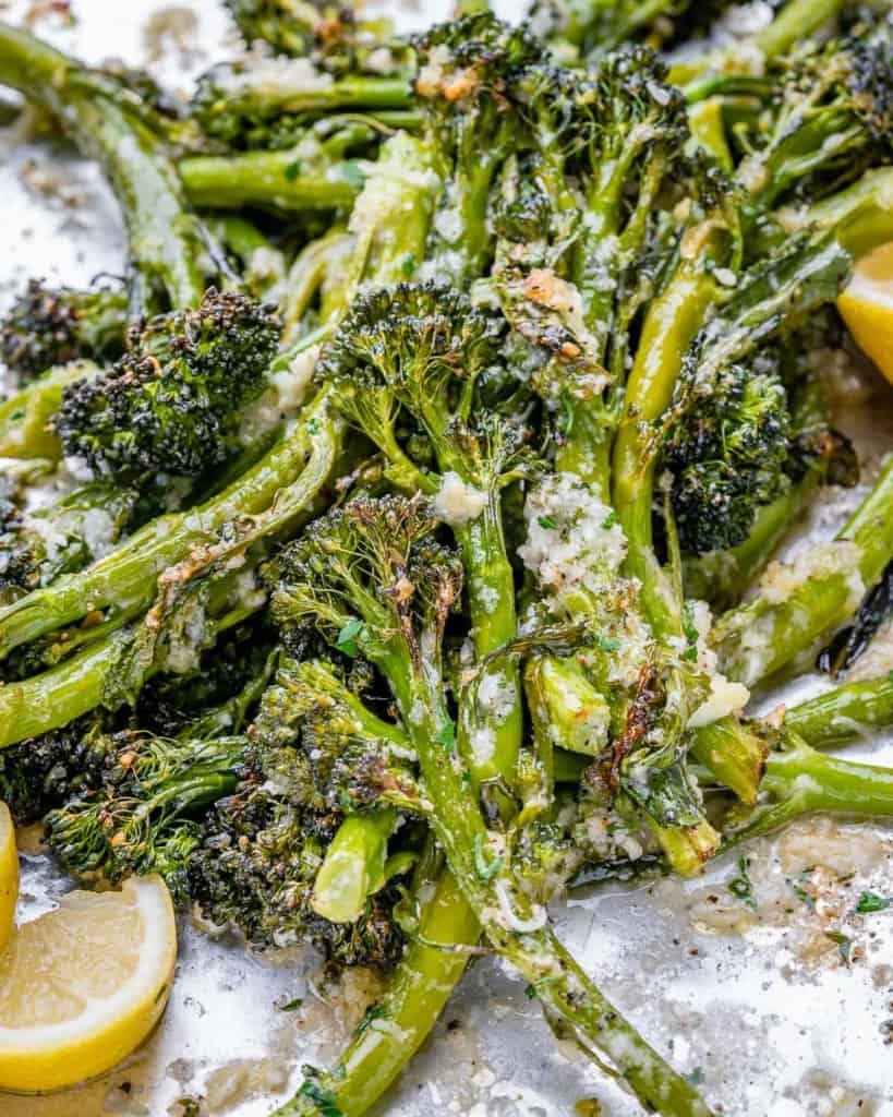 side shot of roasted broccolini on a pan 