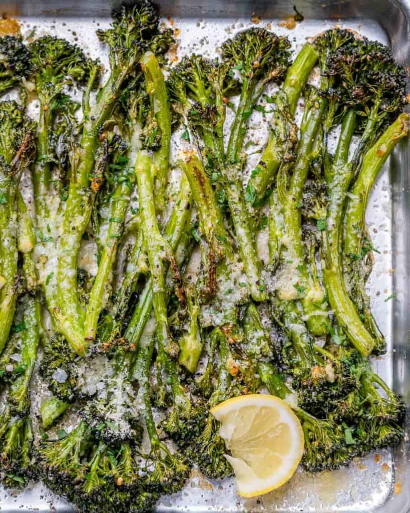 top view of roasted broccolini on a baking pan