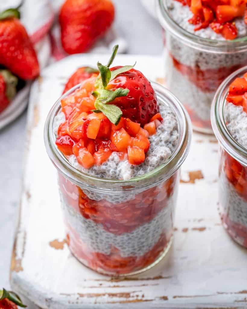 top view chia seed pudding in a jar, topped with fresh strawberries 
