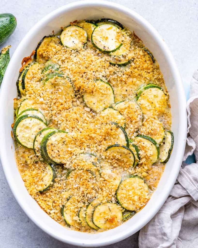 top view zucchini casserole baked in a white dish