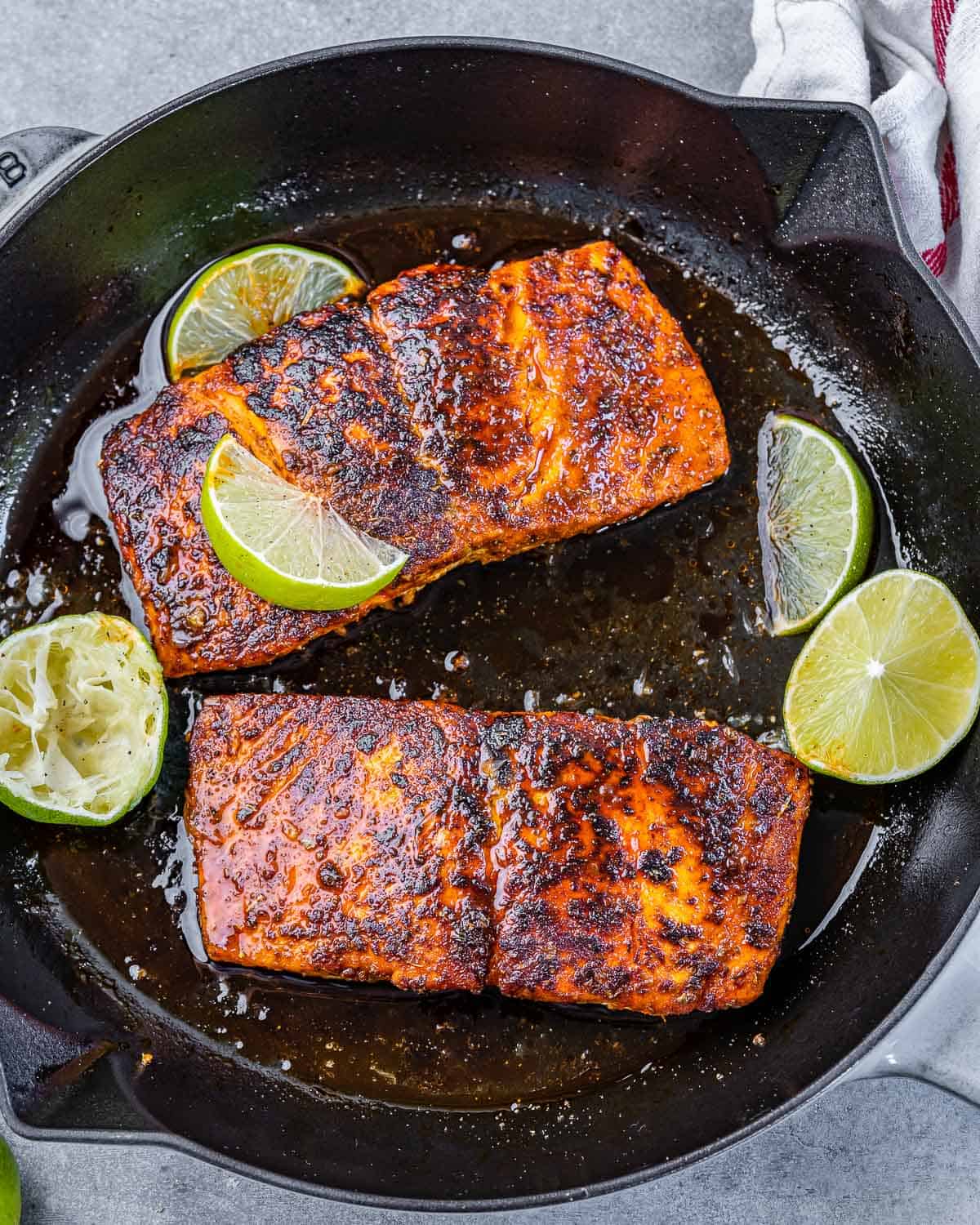 two salmon fillets in skillet