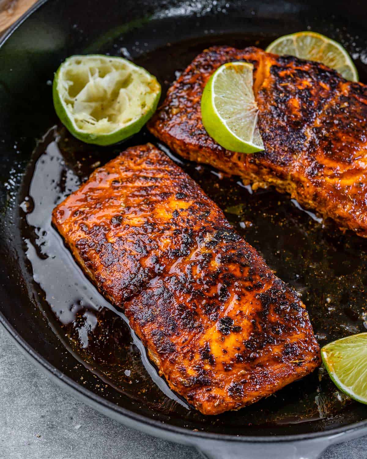 salmon in skillet with lime and oil 