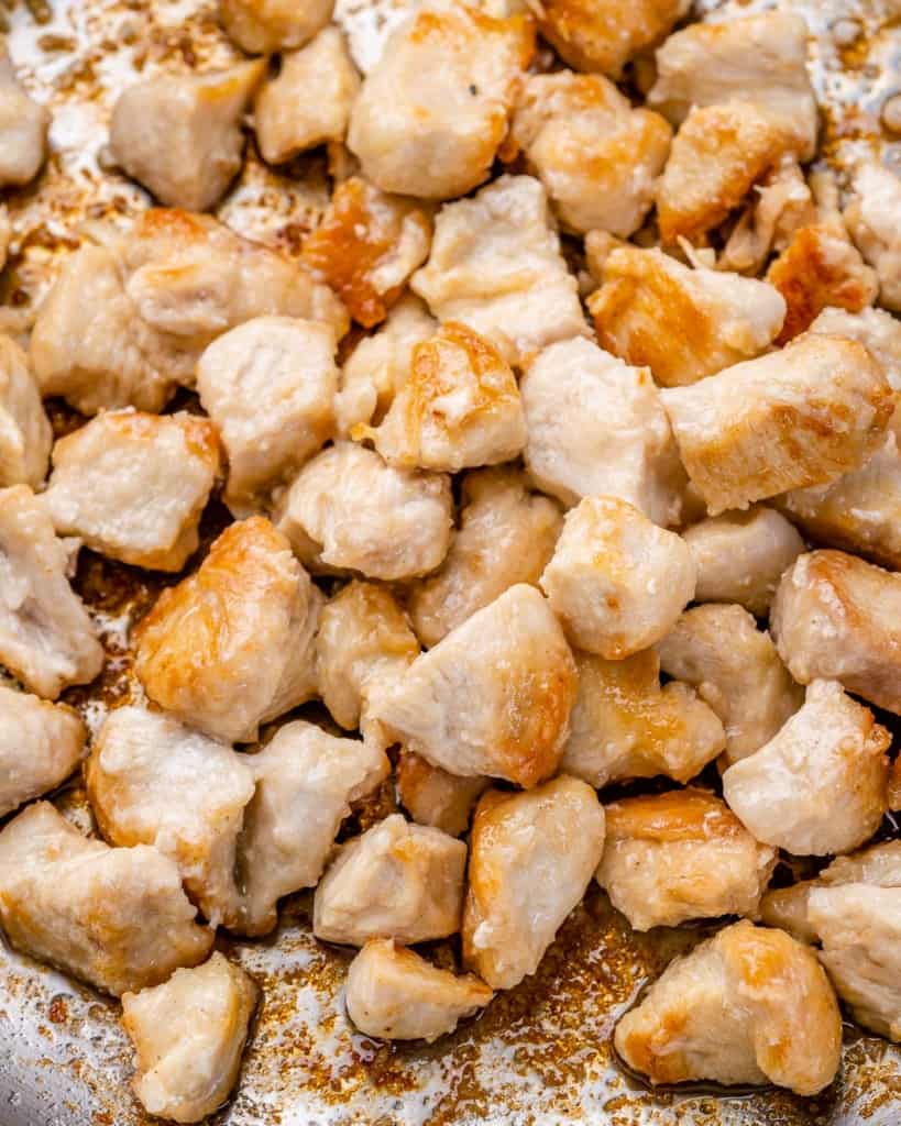 cooked chicken chunks in skillet to be used for stir fry