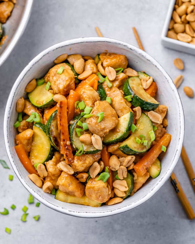 top view chicken stir fry in a white bowl