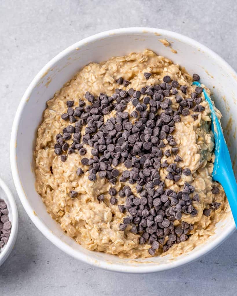 chocolate chips added over a bowl or oatmeal mixture before baking