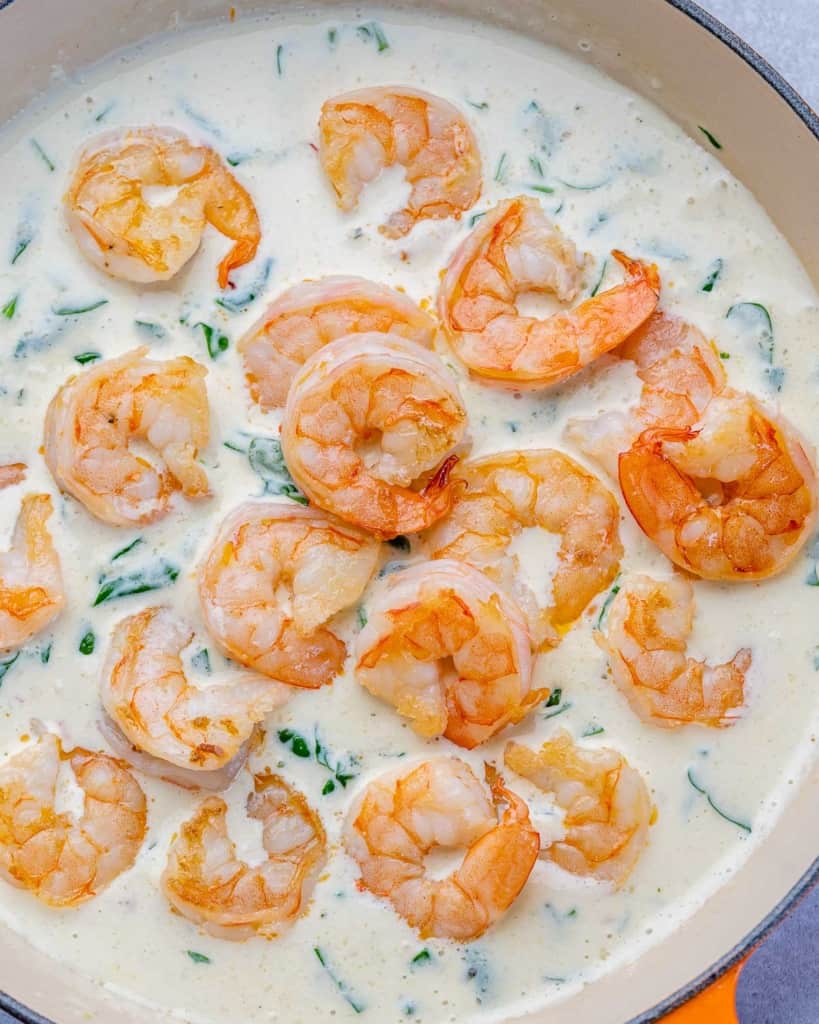 top view sauteed shrimp over a creamy sauce 