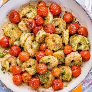 top view pesto shrimp sauteed with cherry tomatoes in a pan