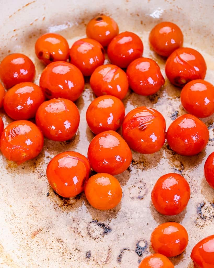 blistered  cherry tomatoes in a skillet