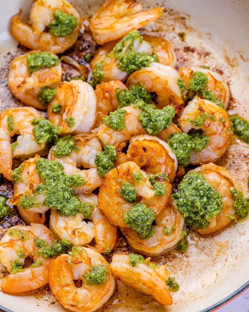 pesto sauce added over sauteed shrimp