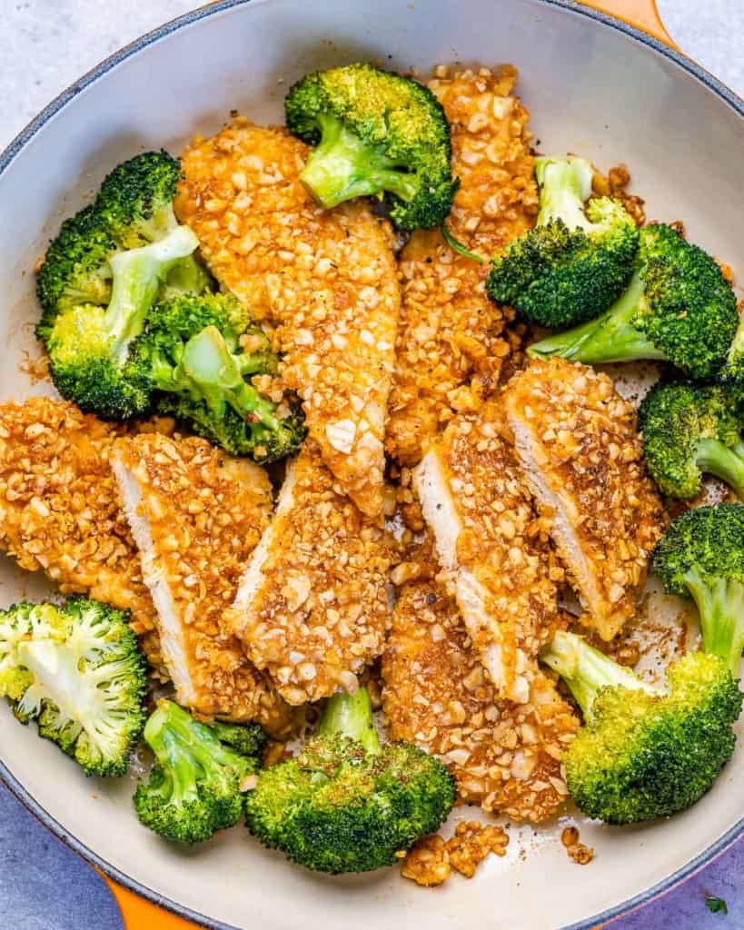 tope view sliced crusted  chicken breast with sauteed broccoli