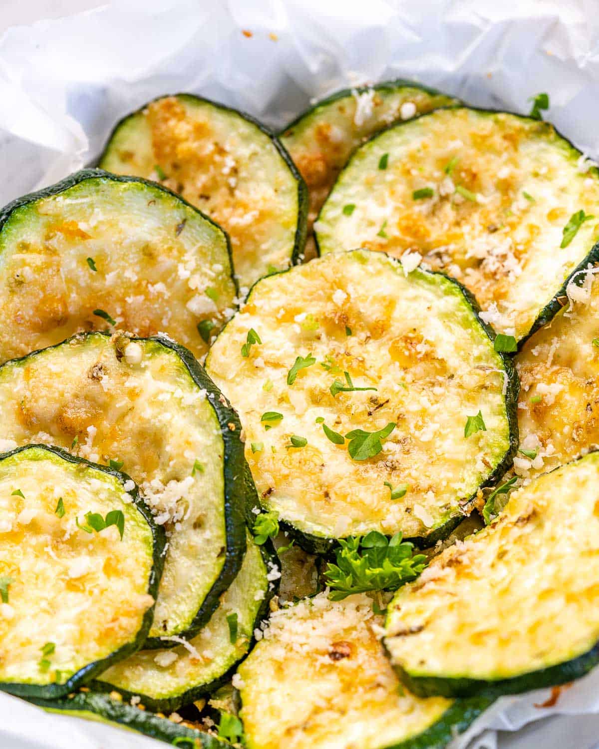 up close image of baked zucchini chips with parmesan