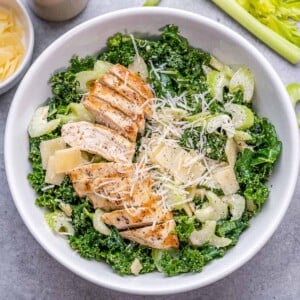 top view chicken kale salad in a white bowl