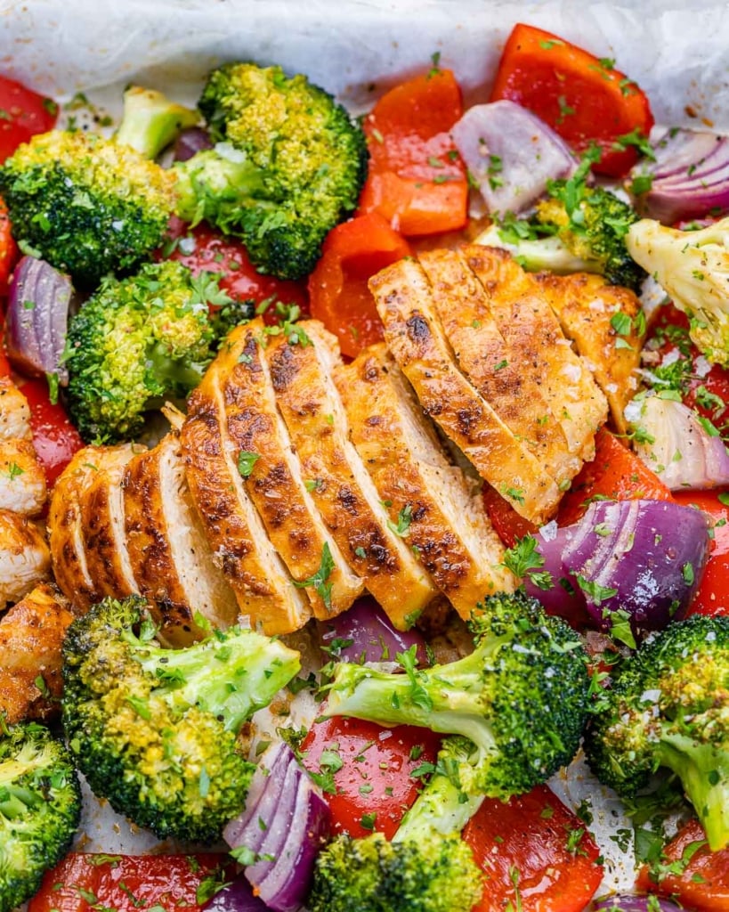close up sliced chicken breast with roasted veggies 