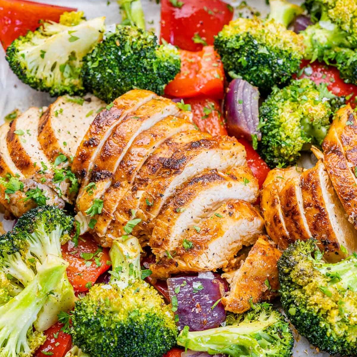 side shot of sliced chicken breast with roasted veggies